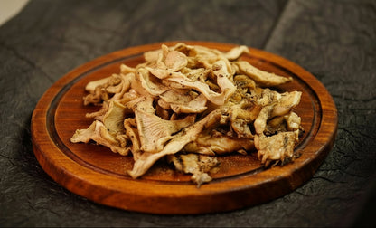 dry oyster mushrooms on a wooden tray