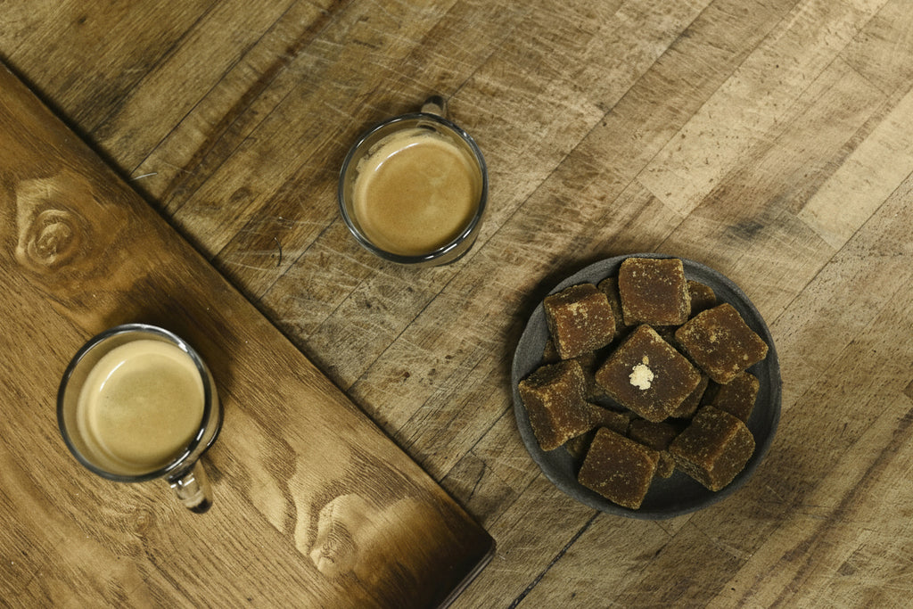 jaggery placed in bowl with two tea cups